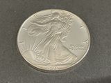 a close up of a silver coin on a black surface