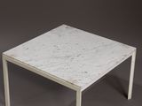 a white table with a marble top on a grey background