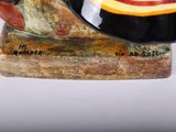 a snail that is sitting on top of a piece of wood