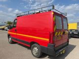 a red van that is parked in a parking lot