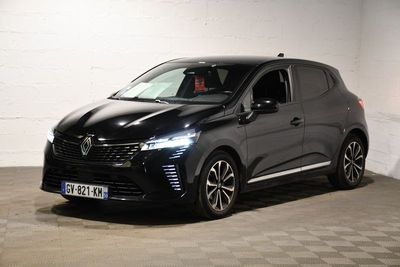 the black car is parked in a garage with a checkered floor