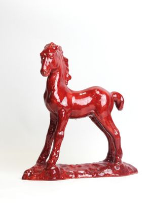 statue of a red horse on a white background