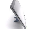 a tablet computer sitting on a stand on a white surface