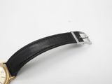 a close up of a watch on a white surface with a black strap