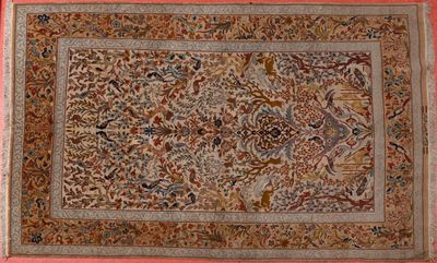 an antique persian rug with a floral design on a pink background