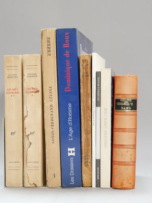 several books are stacked on top of each other on a white surface