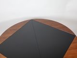 an image of a black umbrella sitting on top of a wooden table
