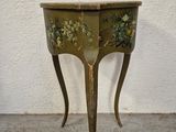 a small table with a flower design on it