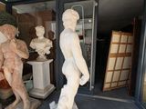 a statue of a man standing next to a statue of a man