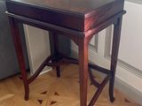 une petite table avec un plateau en bois sur un sol en bois dur