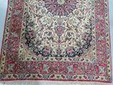 a close up of a rug on a white surface with a blue background