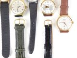 a lot of watches that are sitting together on the table