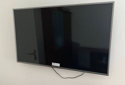 a flat screen tv hanging on the wall in the living room