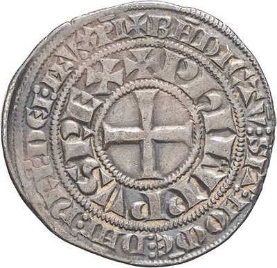 a close up of a coin with a cross on it