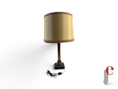 a lamp that is sitting on the floor next to a lamp