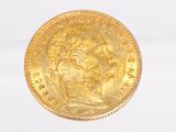 a close up of a gold coin on a white surface