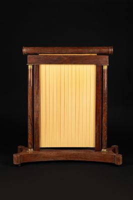 a wooden table with a lamp on top of it on a black background