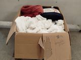 a cardboard box filled with clothes on the floor
