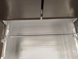 a stainless steel refrigerator with the door open and the door open