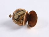 an image of a close up of a pocket watch on a white surface