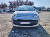 a small silver car parked in a parking lot