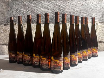 six bottles of wine are lined up in a row on a table