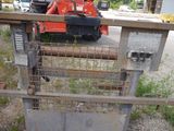 a small tractor that is parked behind a gate
