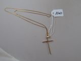 deux colliers en or avec une croix et une plaque sur fond blanc