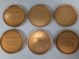 six gold medals with the names of different countries on them
