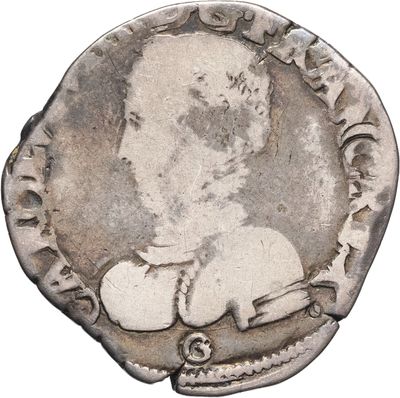 une pièce d'argent sur laquelle figure l'image d'un homme