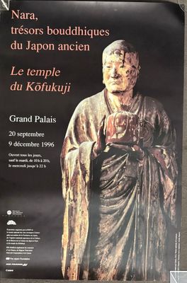 une affiche représentant la statue d'un homme tenant un livre