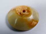 a picture of a yellow and white donut on a white surface