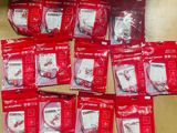a lot of red bags of toothbrushes sitting on a table