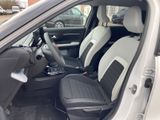 the interior of a small white car with black leather seats