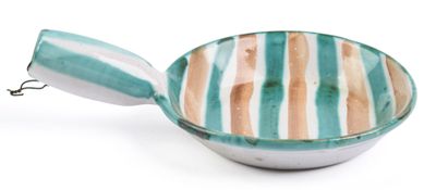 a bowl with a spoon in it on a white surface