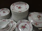 a lot of plates and bowls on the table
