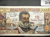 un ancien billet de banque sur lequel figure l'image d'un homme tenant une pipe