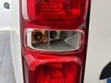 a close up of a car ' s tail light with a dog in the back