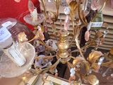 a gold chandelier that has a lot of glass ornaments on it