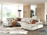 a living room with a large sectional couch and a rug