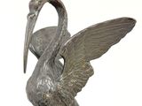 a statue of a bird that is sitting on top of a table
