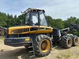 un tracteur jaune garé sur un chemin de terre