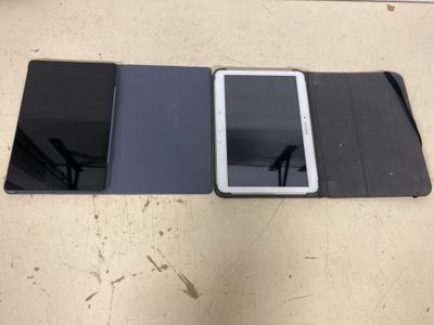 a tablet computer sitting on top of a table next to a cell phone