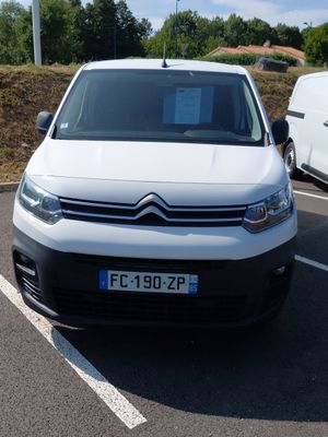 a white van parked in a parking lot next to a white van