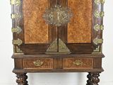 an old wooden cabinet with two doors and a drawer on top of it