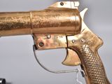 a gold gun that is being held by a person