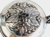 a silver plate with a floral design on it
