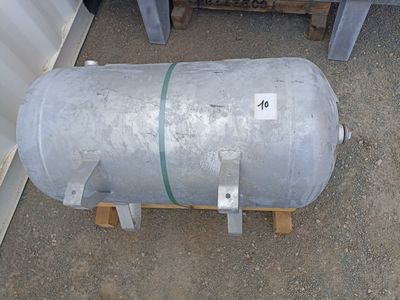 a metal tank sitting on top of a wooden pallet