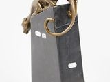 bronze sculpture of a monkey sitting on top of a black block