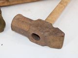 a hammer and a pair of shoes on a table